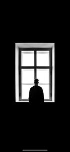 Image of a person looking out of a window.